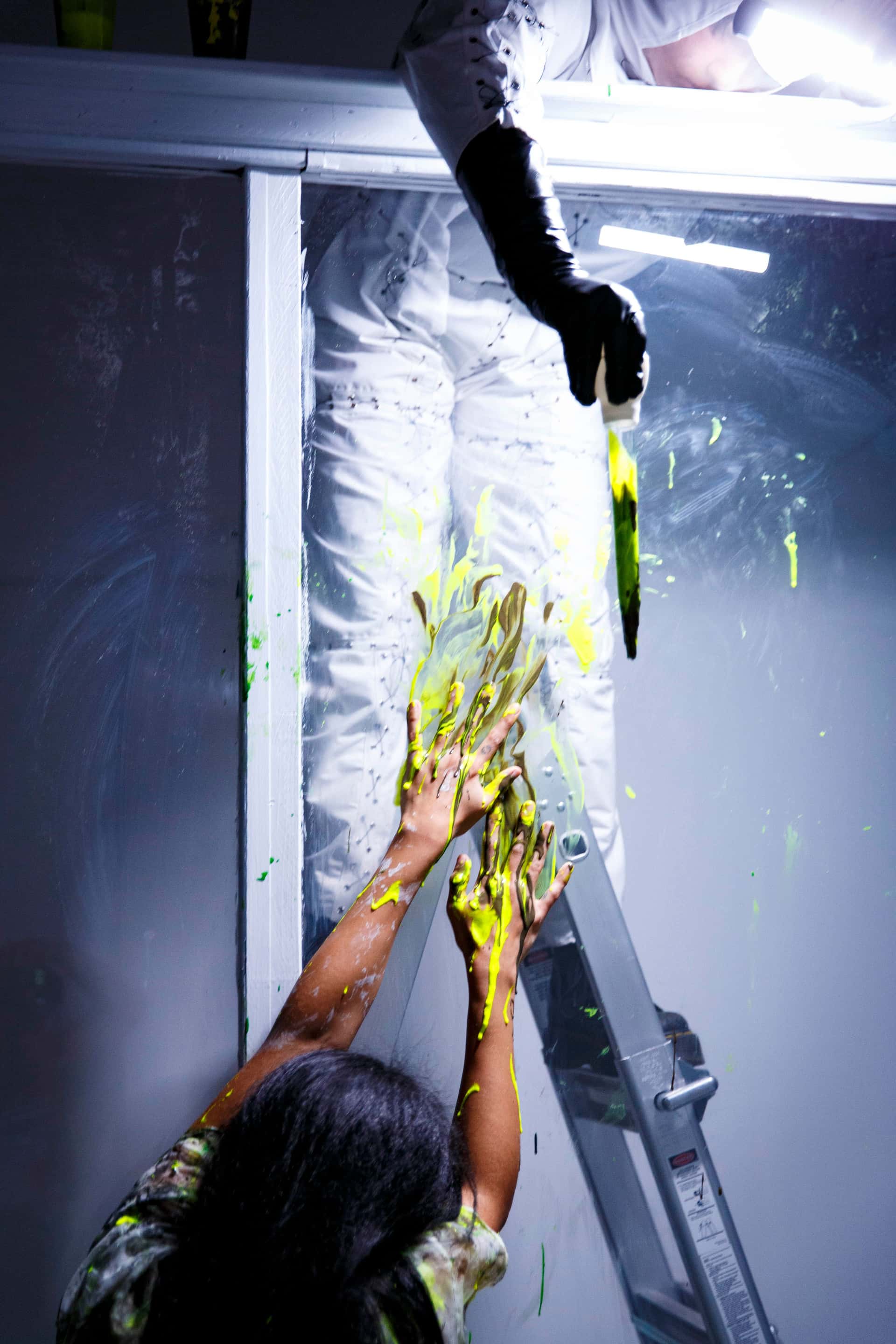 La Llorona performance, a performance in a hazmat suit drops of a green liquid onto La Llorona from above